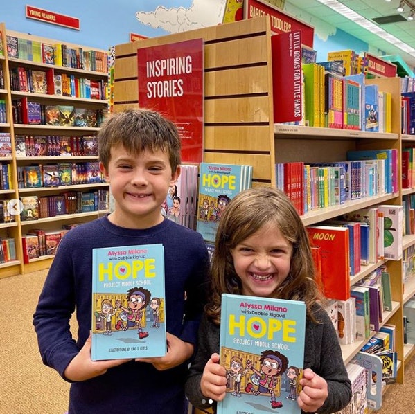 Milano's two children Milo and Elizabella buying copies of their mother's book in NYC