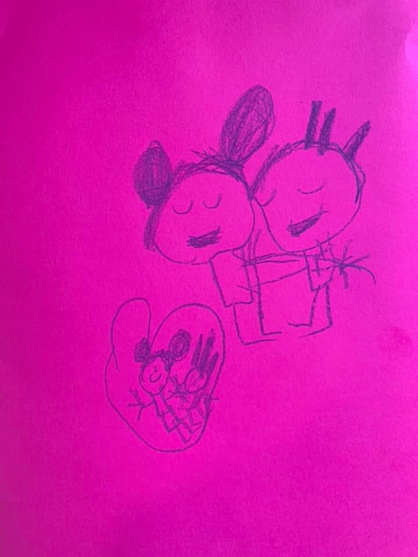Child's drawing of two figures hugging and a heart.