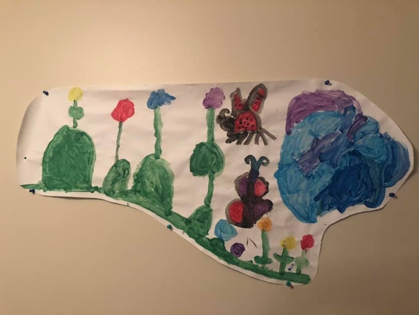 Child's painting of a hill, flowers, a ladybug, a butterfly, and a pond.